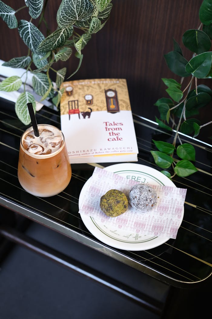 Relax in a cozy Istanbul cafe with iced coffee, pastries, and a book amidst lush greenery.