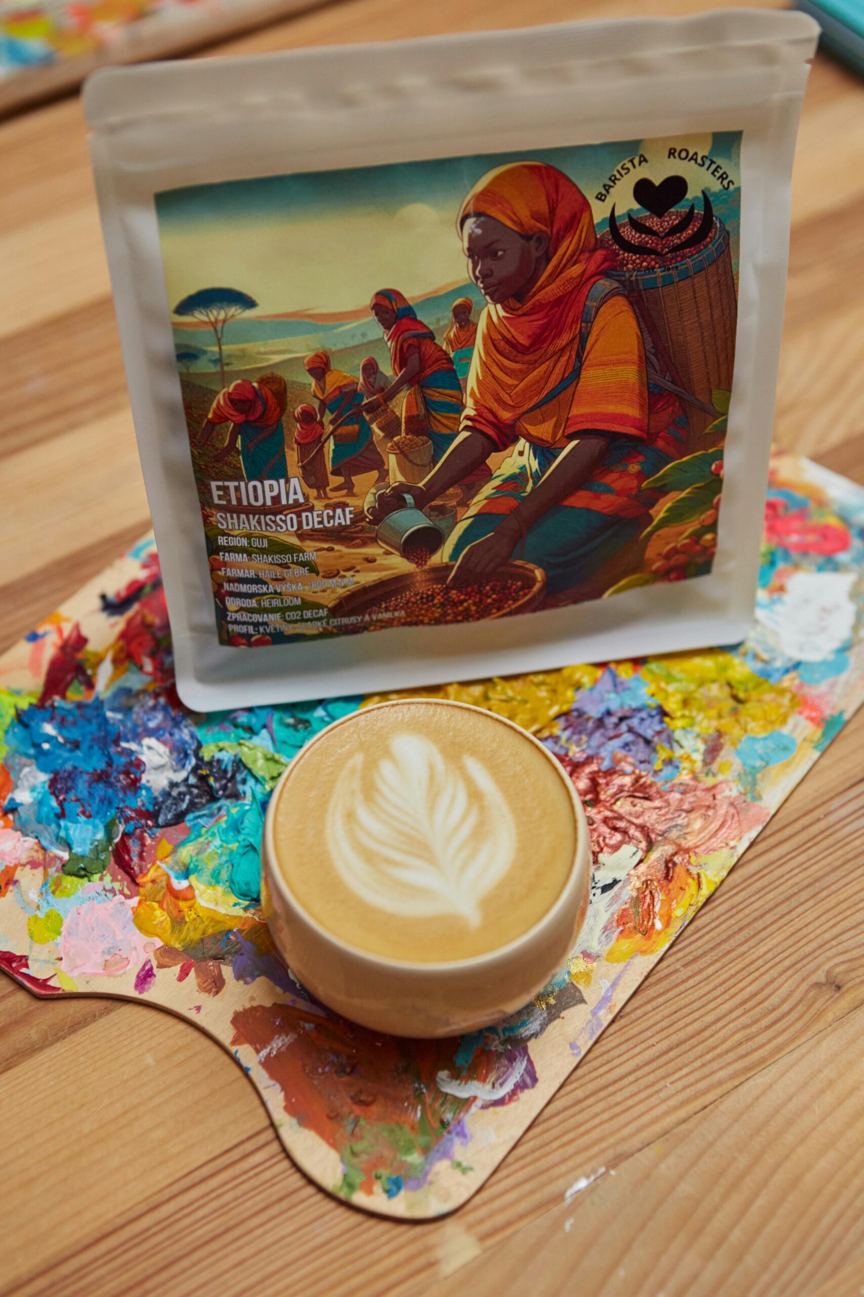 Ethiopian coffee cup with artistic froth art on a vibrant palette in Slovakia cafe.